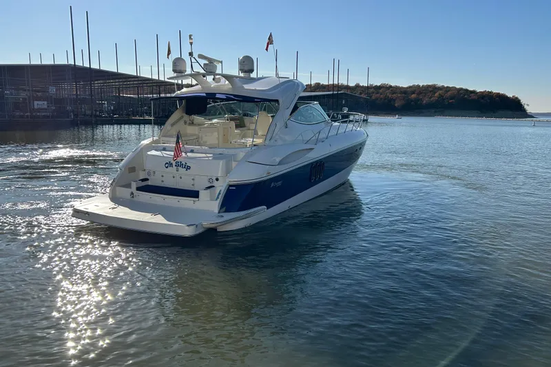 Slide: The Image of 2005 Cruisers 500 yacht on calm water near marina, sunny day. - 43