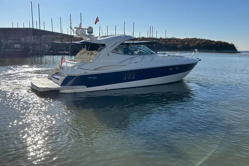 Slide: The Image of 2005 Cruisers 500 yacht on calm water near marina, sunny day. - 5