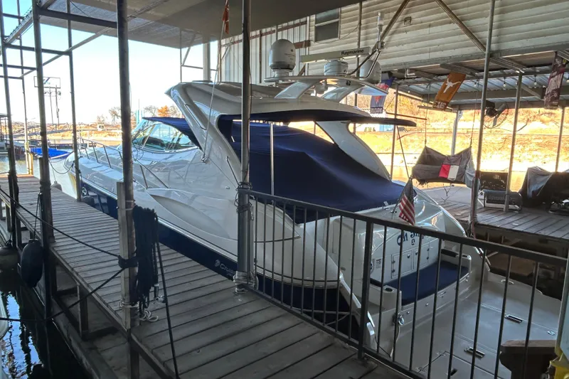 Slide: The Image of 2005 Cruisers 500 yacht docked in a marina, covered and well-maintained. - 7