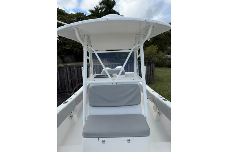 Slide: The Image of 2004 Regulator 24 Forward Seating boat with cushioned seating and T-top canopy. - 12