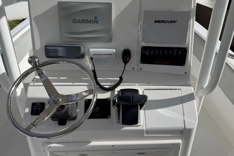 Slide: The Image of 2004 Regulator 24 Forward Seating boat dashboard with Garmin and Mercury controls. - 14