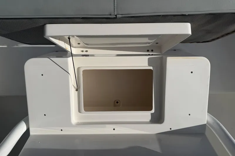 Slide: The Image of Open storage compartment on a 2004 Regulator 24 Forward Seating boat. - 16