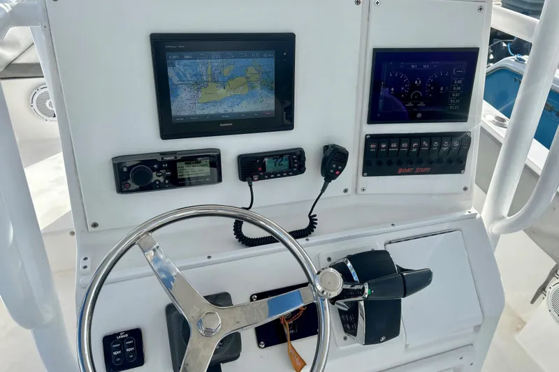 Slide: The Image of 2004 Regulator 24 Forward Seating boat dashboard with navigation and control instruments. - 5