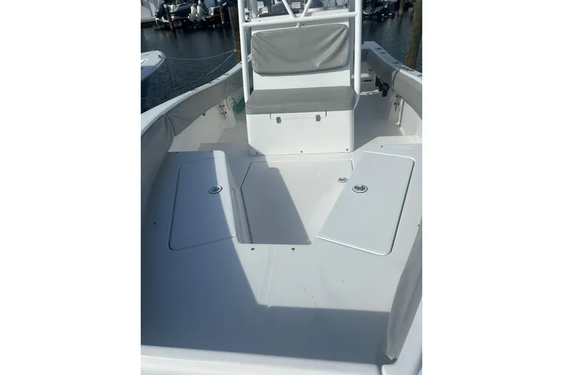 Slide: The Image of 2004 Regulator 24 Forward Seating boat interior with storage compartments and seating. - 7