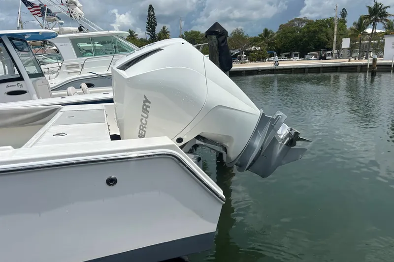 Slide: The Image of 2004 Regulator 24 Forward Seating boat with Mercury outboard engine at marina. - 8
