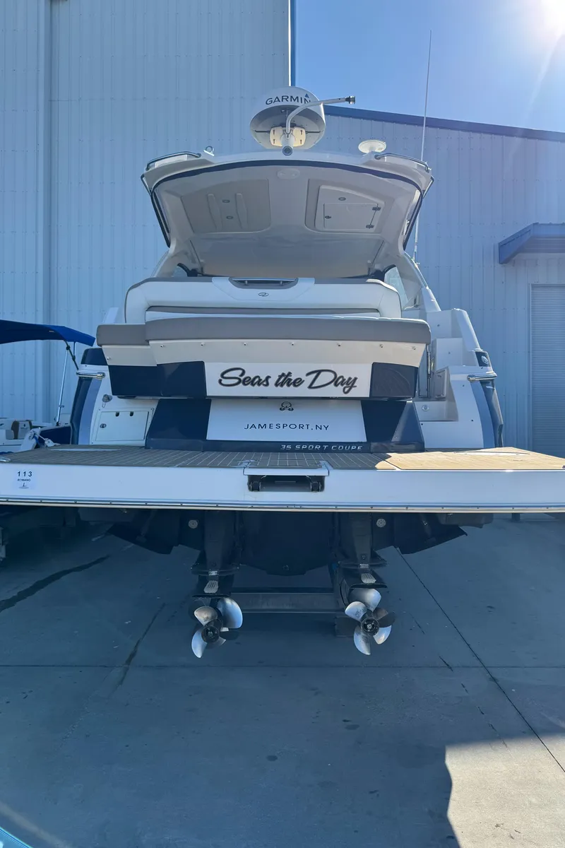 Slide: The Image of 2016 Regal 35 Sport Coupe yacht docked, rear view with "Seas the Day" nameplate. - 13