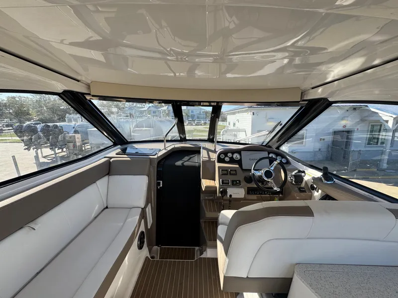 Slide: The Image of Interior of a 2016 Regal 35 Sport Coupe boat, featuring a sleek cockpit and seating area. - 15