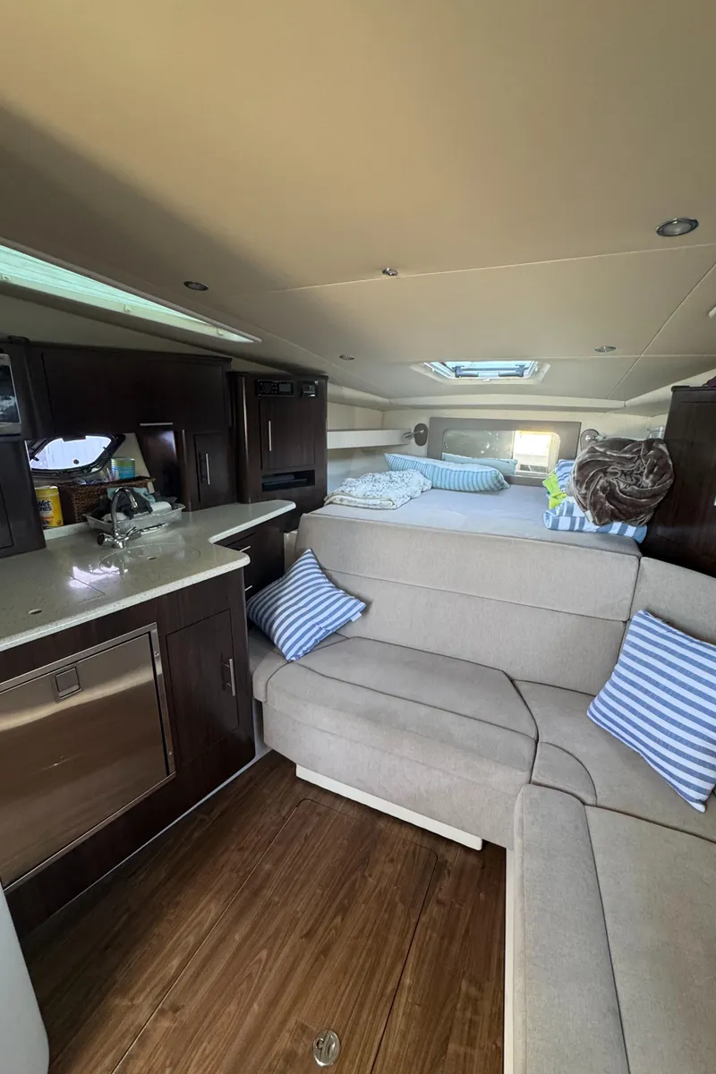 Slide: The Image of Interior of 2016 Regal 35 Sport Coupe with modern kitchen and cozy seating area. - 29