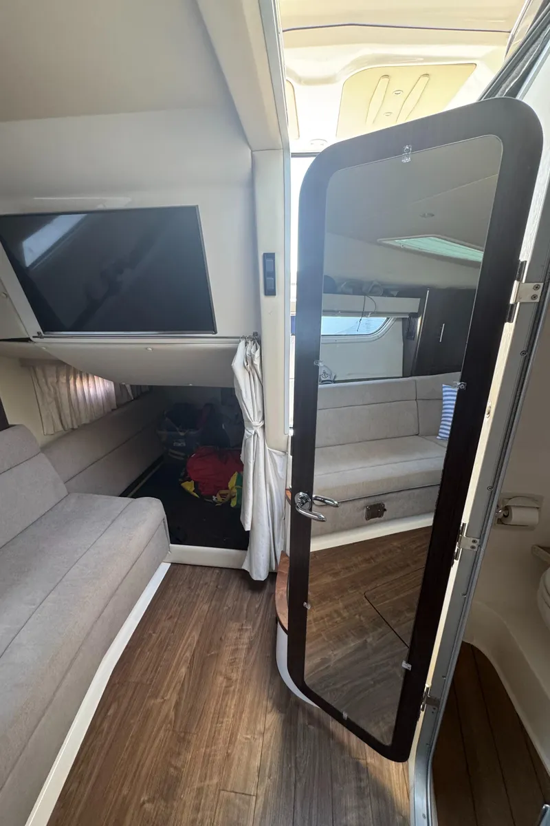 Slide: The Image of Interior of a 2016 Regal 35 Sport Coupe, featuring a cozy seating area and modern amenities. - 30