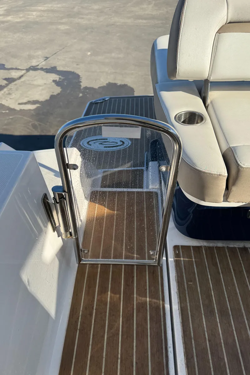 Slide: The Image of 2016 Regal 35 Sport Coupe boat with open glass gate and cushioned seating. - 43