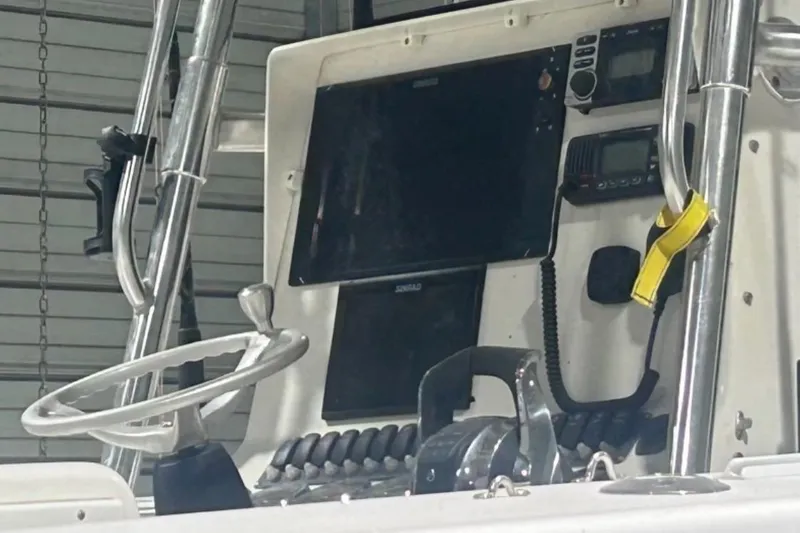 Slide: The Image of 2005 Contender 35 ST boat dashboard with steering wheel and navigation equipment. - 6