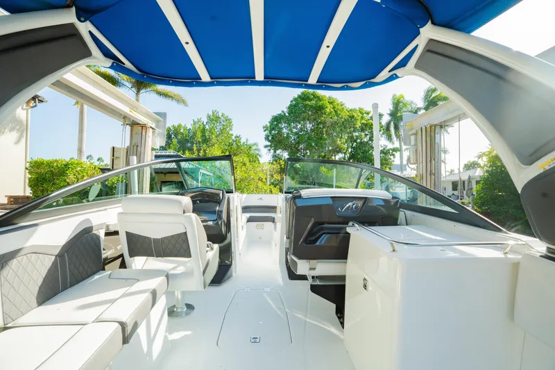 Slide: The Image of 2021 Monterey 255SS Super Sport boat interior with blue canopy and luxurious seating. - 11