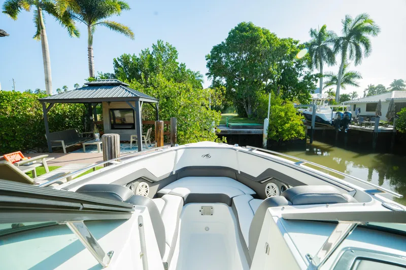 Slide: The Image of 2021 Monterey 255SS Super Sport boat docked near lush greenery and a gazebo. - 12