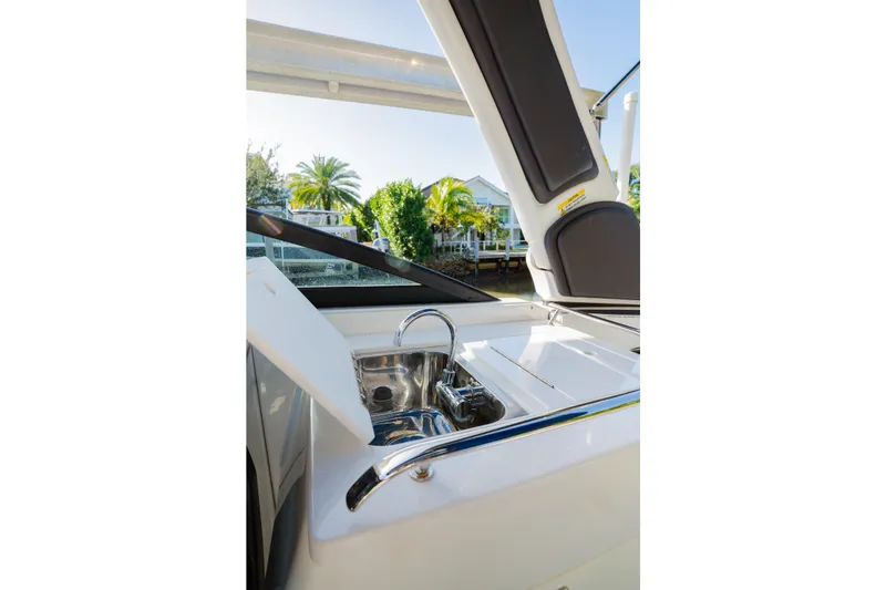 Slide: The Image of 2021 Monterey 255SS Super Sport boat with open sink and sunny background. - 13