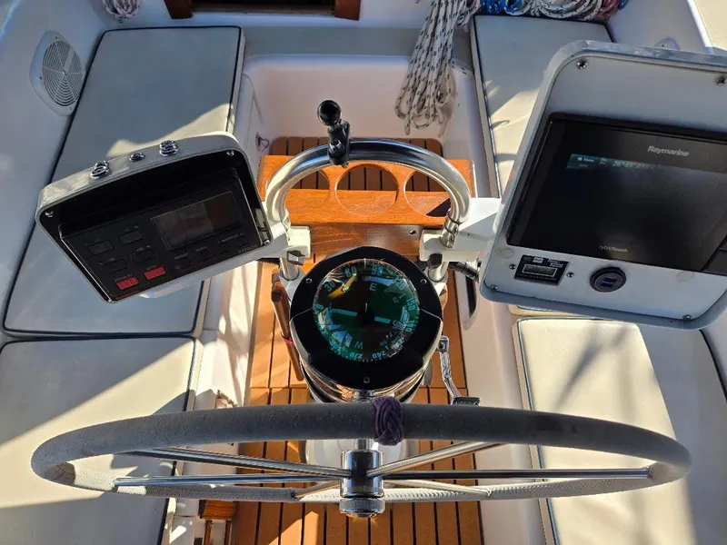 Slide: The Image of Cockpit of 1991 Freedom F-38 sailboat with navigation instruments and steering wheel. - 11