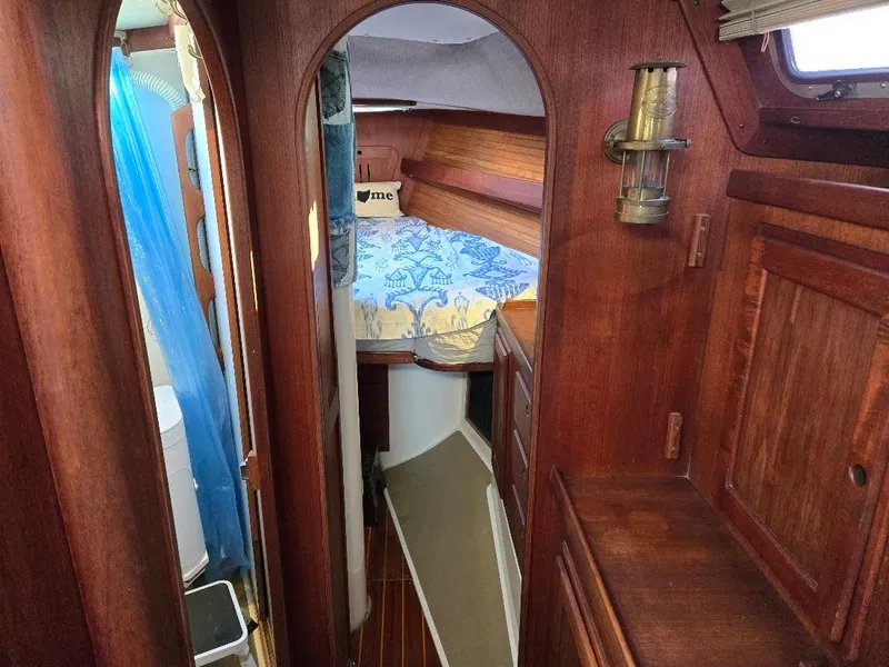 Slide: The Image of Cozy cabin interior of 1991 Freedom F-38 sailboat with wooden finishes and bed. - 12