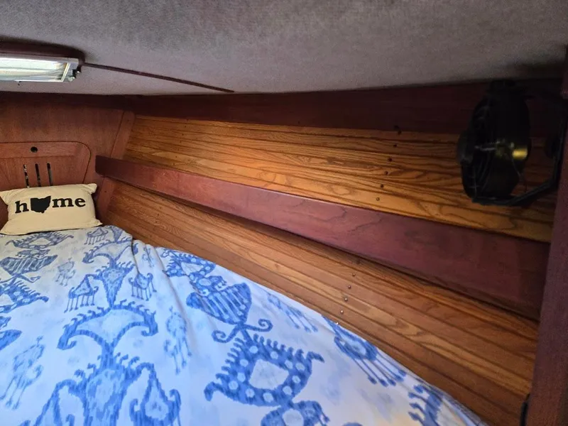 Slide: The Image of Cozy cabin interior of 1991 Freedom F-38 sailboat with wooden walls and patterned bedding. - 15
