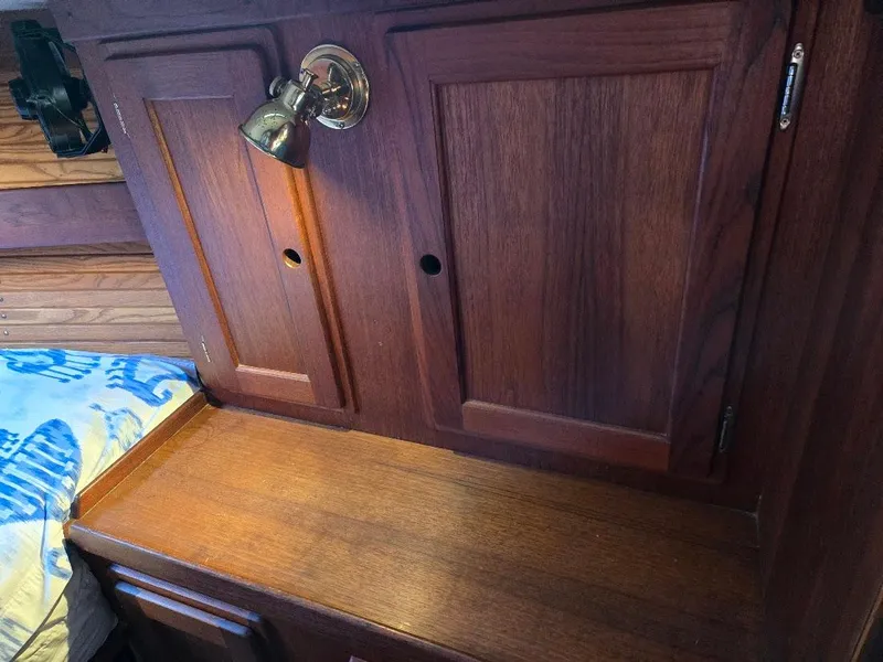 Slide: The Image of Wooden interior of 1991 Freedom F-38 boat with cabinets and a reading light. - 16