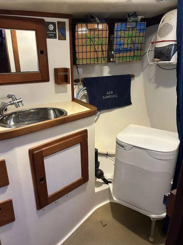 Slide: The Image of Compact bathroom in 1991 Freedom F-38 boat with sink, mirror, and storage. - 19