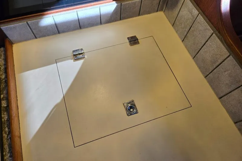 Slide: The Image of Hidden compartment on a 1991 Freedom F-38 boat, featuring a secure latch and hinges. - 36