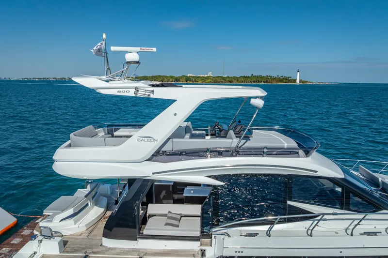 Slide: The Image of 2021 Galeon 500 Fly yacht cruising on blue ocean near a lighthouse. - 10