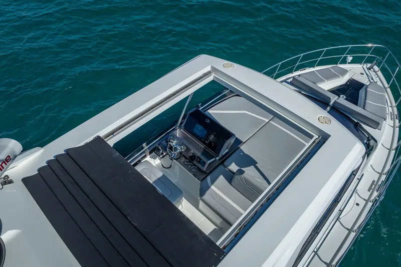 Slide: The Image of 2021 Galeon 500 Fly yacht with sleek design and spacious flybridge on blue water. - 11