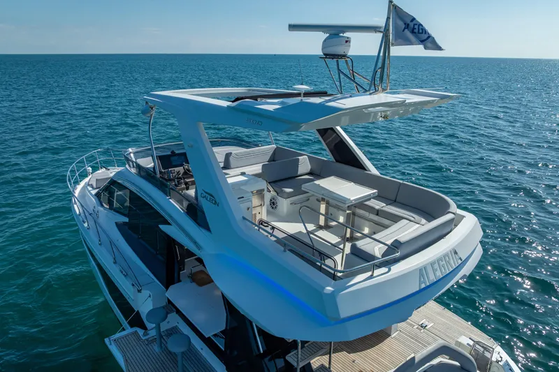 Slide: The Image of 2021 Galeon 500 Fly yacht cruising on open sea, featuring spacious upper deck. - 12