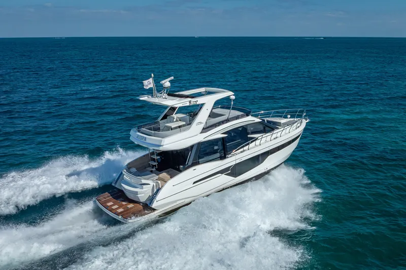Slide: The Image of 2021 Galeon 500 Fly yacht cruising on open sea, showcasing sleek design and luxury features. - 5