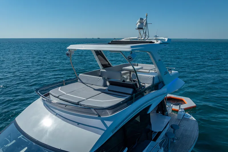 Slide: The Image of 2021 Galeon 500 Fly yacht cruising on open sea, featuring spacious flybridge. - 8