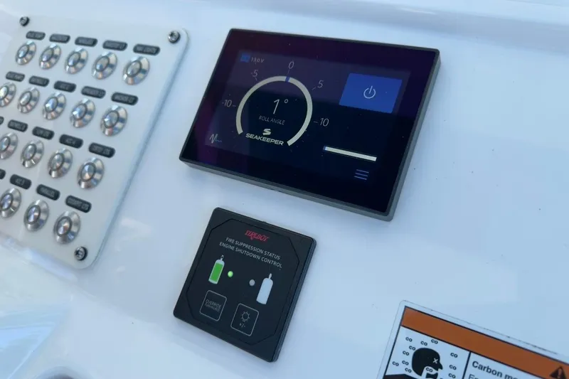 Slide: The Image of Control panel of 2022 Intrepid 407 Panacea featuring Seakeeper and fire suppression system. - 100