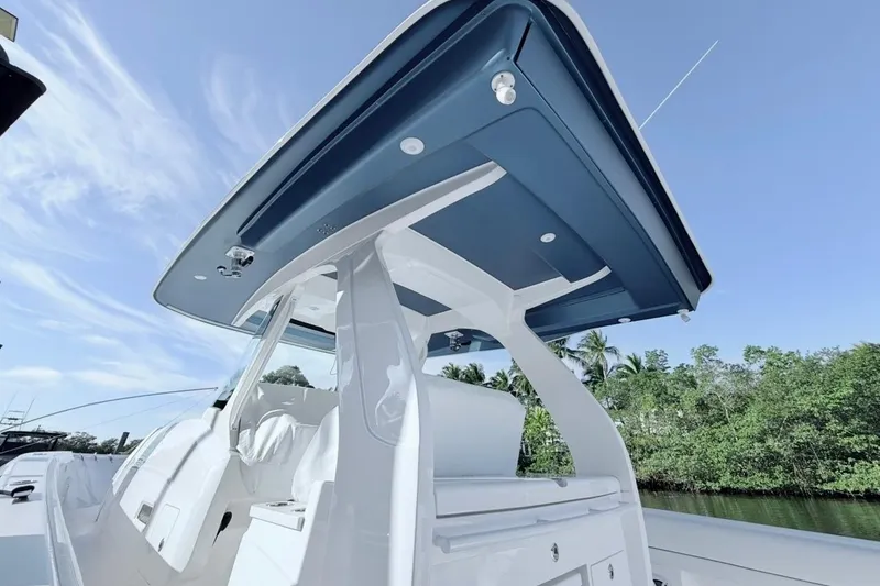 Slide: The Image of 2022 Intrepid 407 Panacea boat with sleek design and modern features, under a clear blue sky. - 11