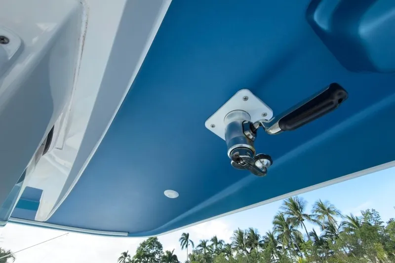 Slide: The Image of 2022 Intrepid 407 Panacea boat detail with blue canopy and handle, tropical background. - 110