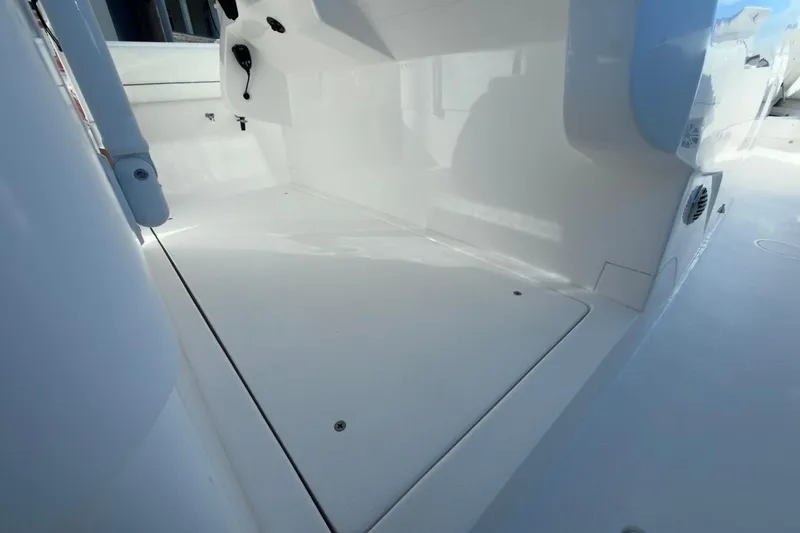 Slide: The Image of 2022 Intrepid 407 Panacea boat interior, showcasing sleek white deck design. - 115