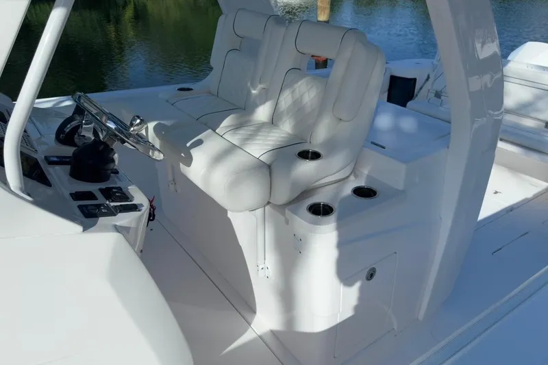 Slide: The Image of 2022 Intrepid 407 Panacea boat interior with white seating and steering console. - 117