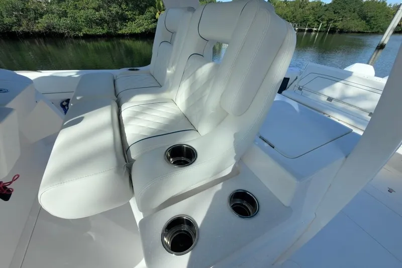 Slide: The Image of White seating with cup holders on a 2022 Intrepid 407 Panacea boat. - 120