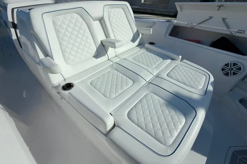 Slide: The Image of Luxurious white seating on 2022 Intrepid 407 Panacea boat, featuring diamond stitching and cup holders. - 122