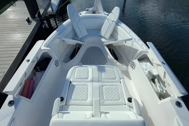 Slide: The Image of 2022 Intrepid 407 Panacea boat interior with white cushioned seating and storage compartments. - 124