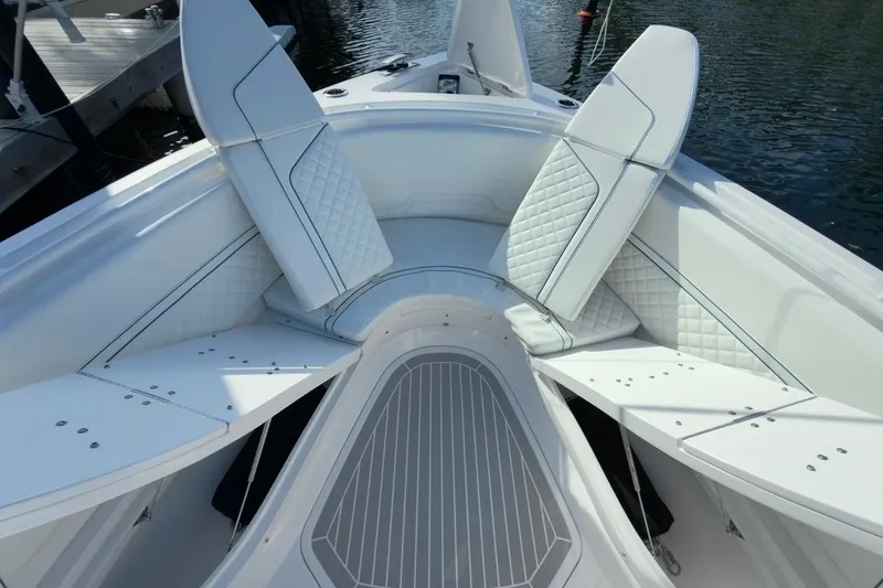 Slide: The Image of 2022 Intrepid 407 Panacea boat interior with white cushioned seating and sleek design. - 130