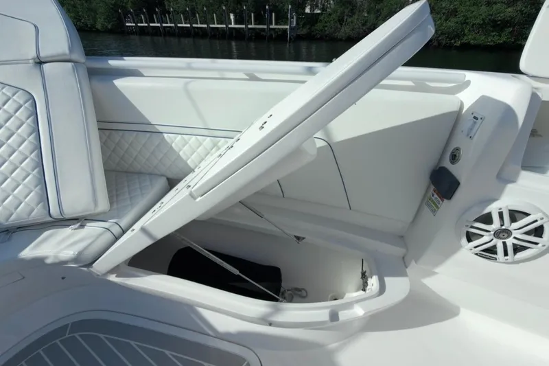 Slide: The Image of 2022 Intrepid 407 Panacea boat with open storage compartment and cushioned seating. - 131