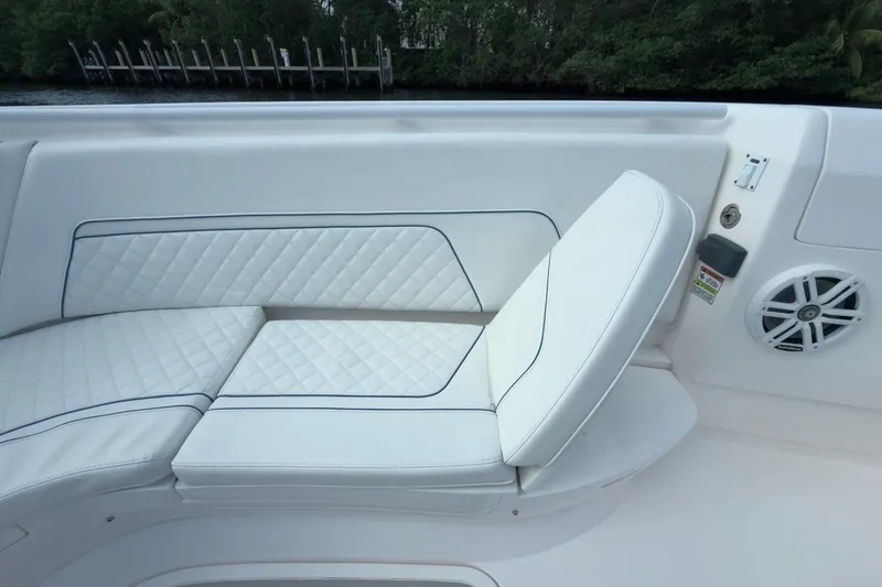 Slide: The Image of 2022 Intrepid 407 Panacea boat seating with white quilted upholstery and speaker. - 132