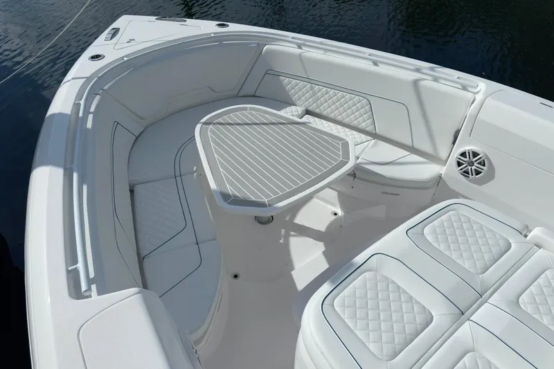 Slide: The Image of Luxurious seating area on 2022 Intrepid 407 Panacea boat with quilted cushions and table. - 137