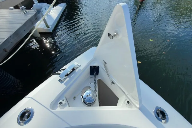 Slide: The Image of 2022 Intrepid 407 Panacea boat anchor compartment open at dock. - 145