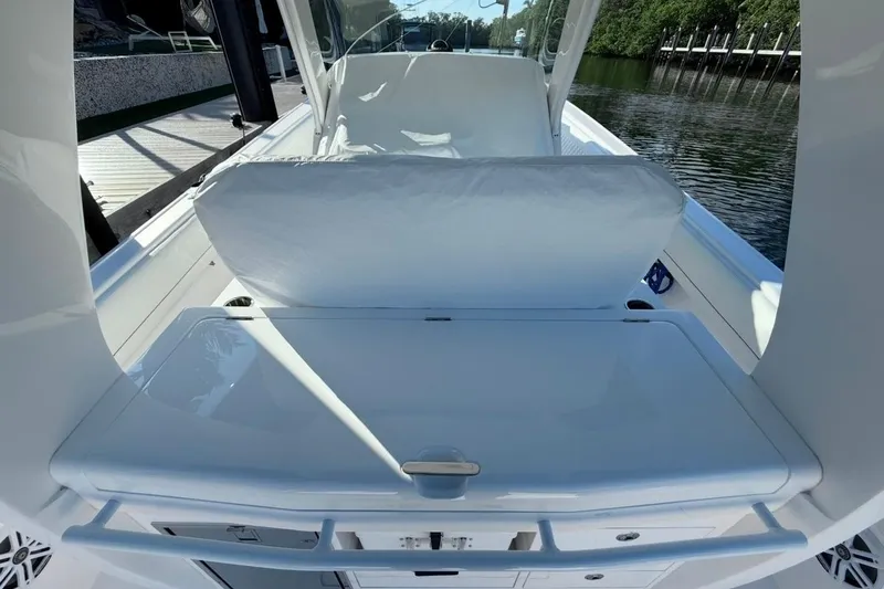 Slide: The Image of 2022 Intrepid 407 Panacea boat interior with sleek seating and storage area. - 15
