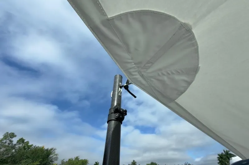 Slide: The Image of 2022 Intrepid 407 Panacea boat canopy against a blue sky with clouds. - 154