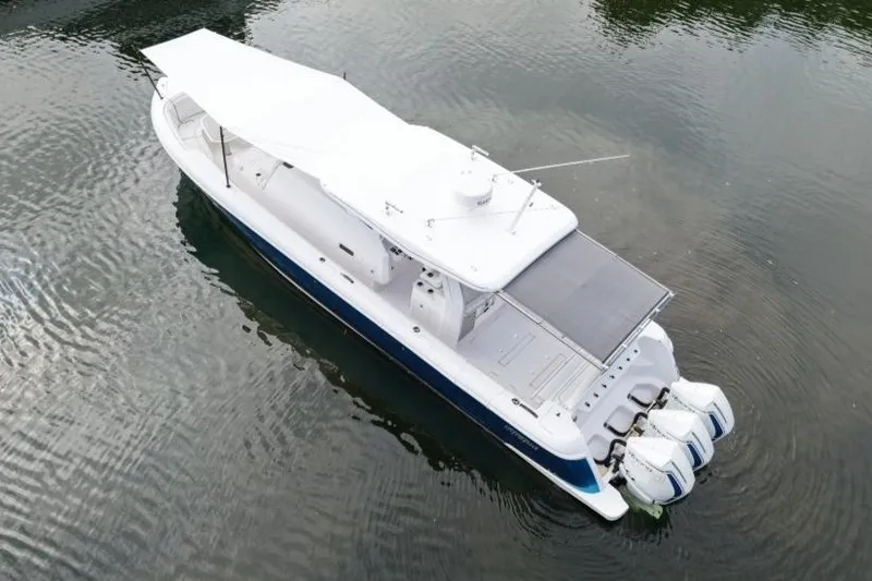 Slide: The Image of Aerial view of 2022 Intrepid 407 Panacea boat with triple outboard engines. - 156