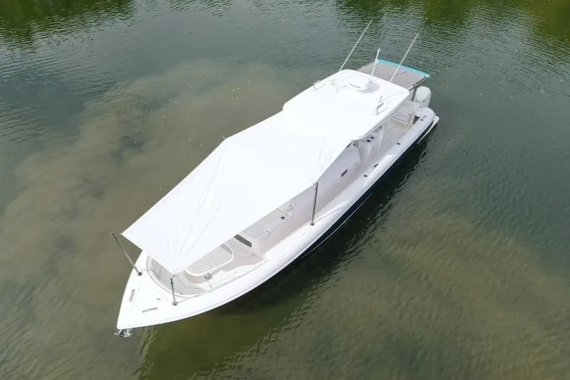 Slide: The Image of Aerial view of 2022 Intrepid 407 Panacea boat with white canopy on calm water. - 157