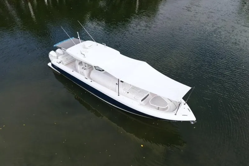 Slide: The Image of 2022 Intrepid 407 Panacea boat with canopy on calm water. - 158