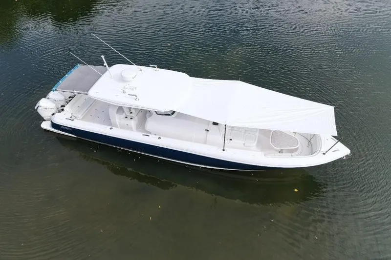 Slide: The Image of 2022 Intrepid 407 Panacea boat with canopy on calm water. - 159