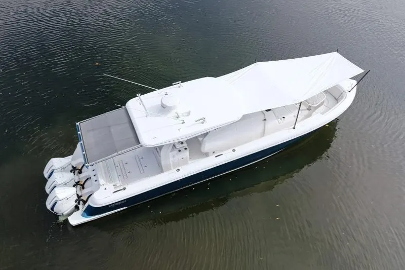 Slide: The Image of 2022 Intrepid 407 Panacea boat with canopy, viewed from above on calm water. - 160