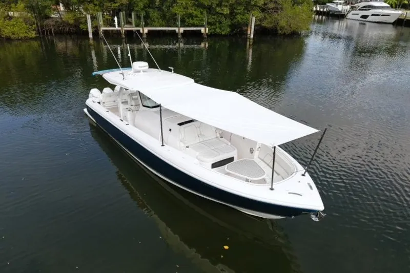 Slide: The Image of 2022 Intrepid 407 Panacea boat with canopy on calm water. - 164